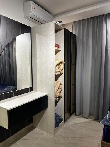 a dressing room with a shelf and a mirror at B15/87/41 · Brand New 3BR Stylish Madinaty in Madinaty