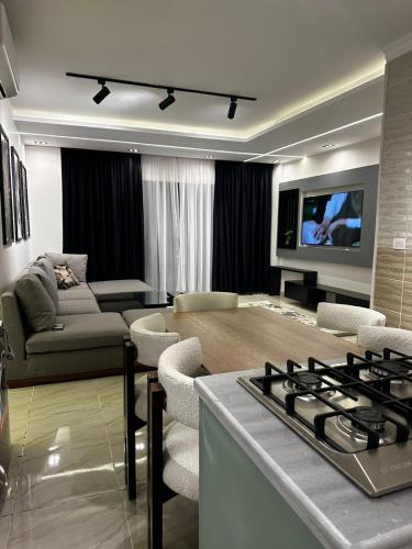 a living room with a couch and a stove at B15/87/41 · Brand New 3BR Stylish Madinaty in Madinaty