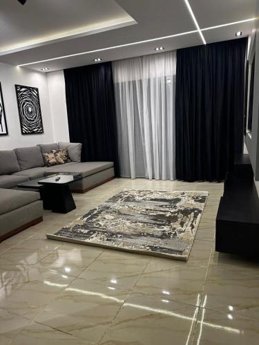 a living room with a couch and a rug at B15/87/41 · Brand New 3BR Stylish Madinaty in Madinaty