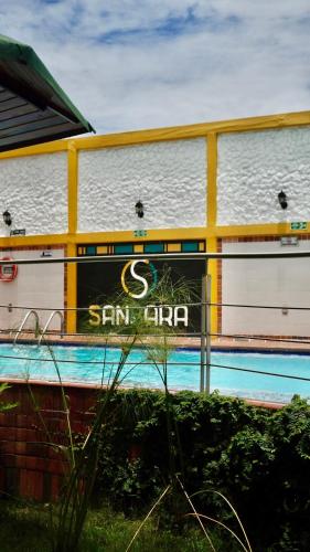 a sign on the side of a building next to a swimming pool at Gran Hotel Internacional Sanbara in Arauca