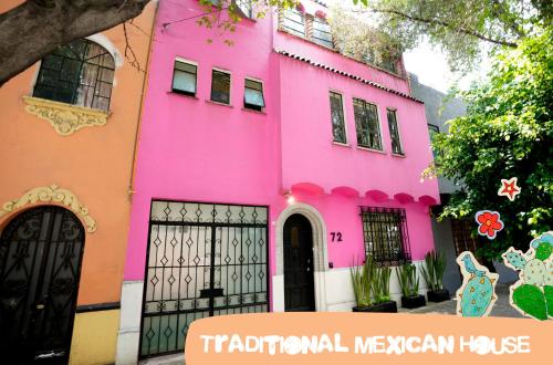 a pink house with the words traditional mexican house at Hostal Fungi Casa Rosa in Mexico City