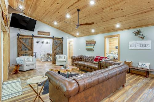 a living room with a leather couch and a tv at Relax on the River Modern Mountain View Escape! in Mountain View