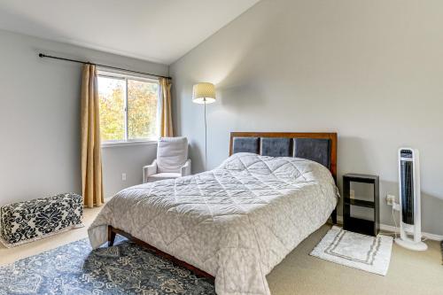 a bedroom with a bed and a chair and a window at Modern Home Close to Dtwn Woodinville with Yard in Woodinville
