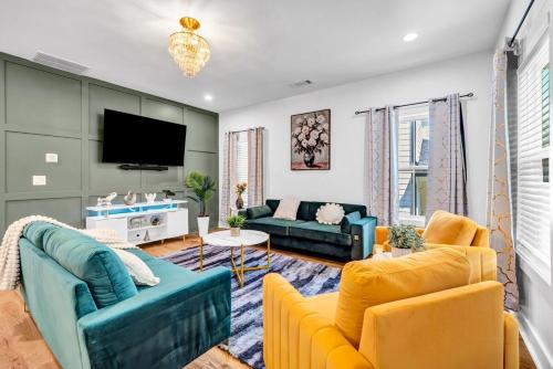 a living room with two couches and a tv at Spacious 7 Bed Home Near Downtown in Atlanta