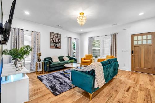 a living room with a green couch and chairs at Spacious 7 Bed Home Near Downtown in Atlanta