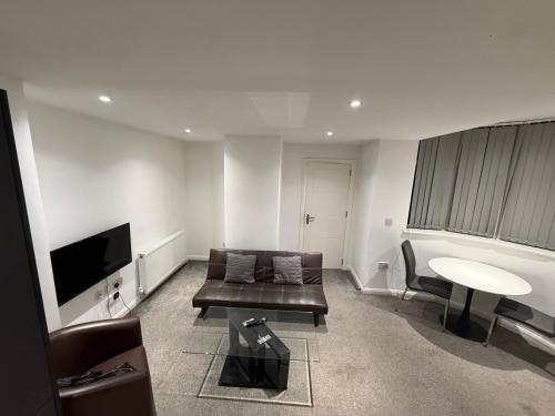 a living room with a couch and a table at City Gate Apartments Manchester in Manchester