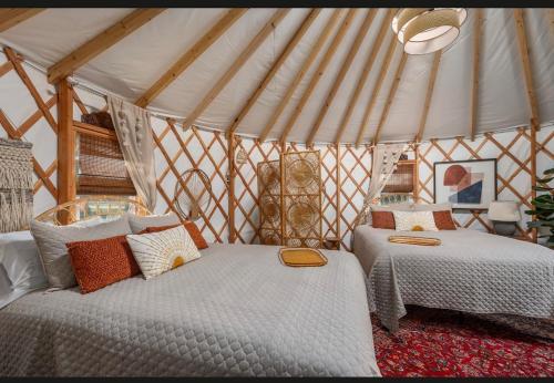 a bedroom with two beds in a yurt at Boho Bliss Yurt - Unit # 4 in Woodway