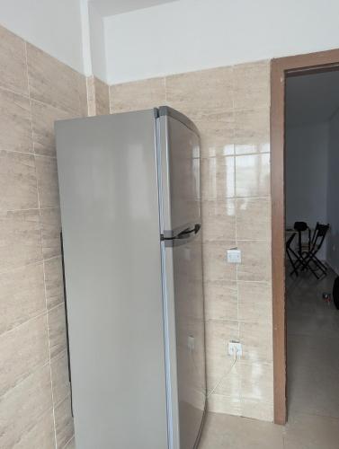 a refrigerator in a room with a wall at Beautiful apart with sea view in Tangier