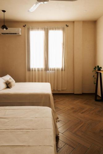 Ένα ή περισσότερα κρεβάτια σε δωμάτιο στο Casa Hotel Izkina