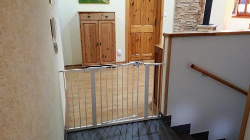 a staircase with a gate in a house at chalupa Slunovrat in Hroznětín