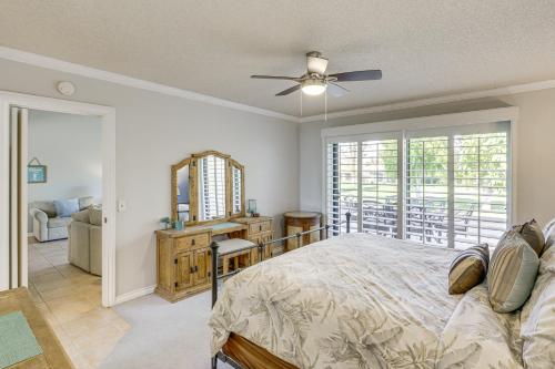 a bedroom with a bed with a ceiling fan at Golf and Swim Country Club Condo in Palm Desert in Palm Desert
