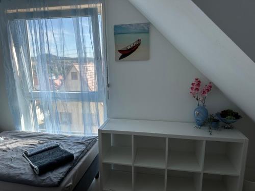 a bedroom with a bed and a window at Guest House BiBi-Lux in Ilsfeld