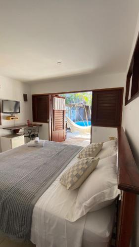 a bedroom with a large bed with a view of a slide at Pousada Aky Jeri in Jericoacoara