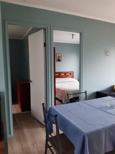 a bedroom with a bed and a table with a blue table cloth at CABAÑA Privada 