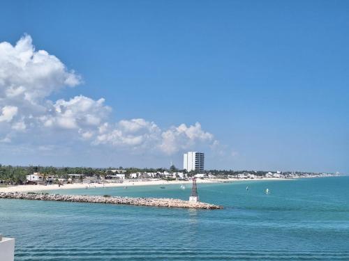 a small island in the water with a lighthouse at Yucalpeten Resort Marina - Dpto de 2 Recámaras en Progreso - Lujo Frente a la Playa & Amenidades Top in Progreso