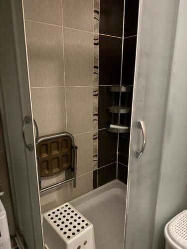 a small bathroom with a shower with a toilet at swiss xhe in Gostivar