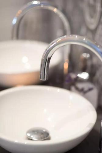 a white sink with a faucet in a bathroom at Santo Copas in Seville