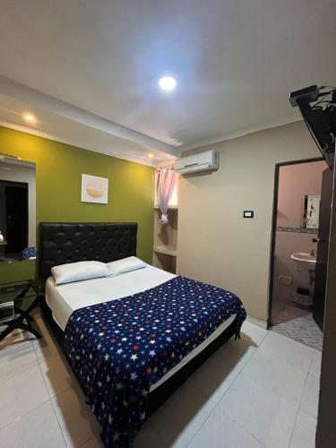 a bedroom with a bed and a bathroom at NaPoles valledupar Hotel in Valledupar