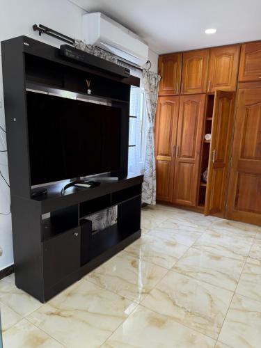 a large black entertainment center with a large flat screen tv at Eco hotel el bosque in Doradal