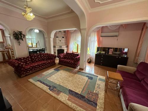 a large living room with couches and a fireplace at Villarome in Çakırlar