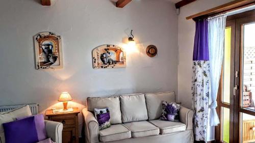 a living room with a couch and a window at chalupa Slunovrat in Hroznětín