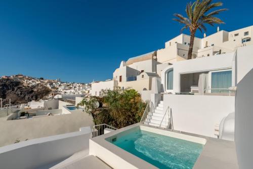 a view of a villa with a swimming pool on a building at Aesthesis Boutique Villas Fira in Fira