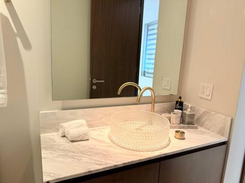 a bathroom counter with a sink and a mirror at Bolongo 2BR your exclusive oceanfront escape in Punta Mita