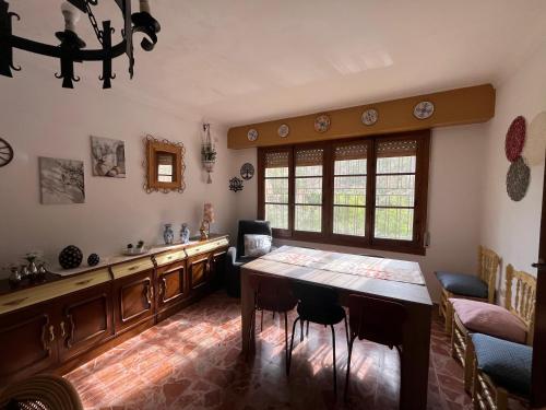 a dining room with a table and a window at Villa Virtudes Ayna in Ayna