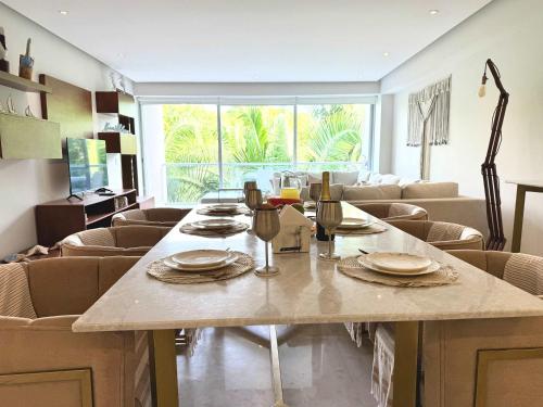 a dining room with a table and chairs at Bolongo 2BR your exclusive oceanfront escape in Punta Mita
