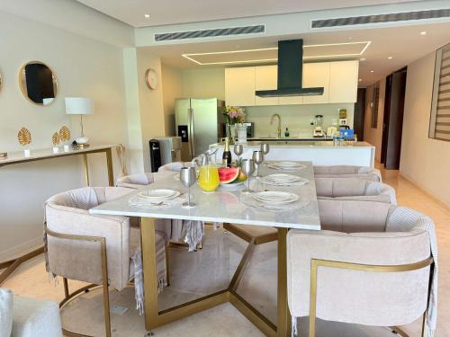a dining room and kitchen with a table and chairs at Bolongo 2BR your exclusive oceanfront escape in Punta Mita