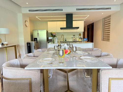 a table in a kitchen with chairs and a dining room at Bolongo 2BR your exclusive oceanfront escape in Punta Mita