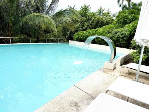 a swimming pool with a water fountain at Bolongo 2BR your exclusive oceanfront escape in Punta Mita