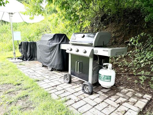 a grill sitting on a brick walkway next to at Bolongo 2BR your exclusive oceanfront escape in Punta Mita