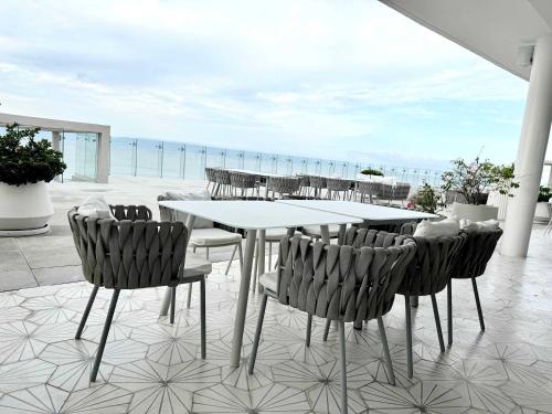 a table and chairs with a view of the ocean at Bolongo 2BR your exclusive oceanfront escape in Punta Mita