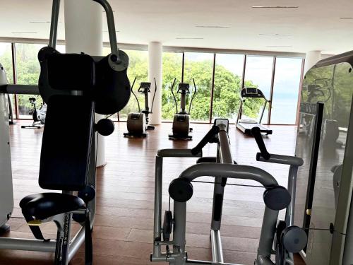 a gym with several cardio machines in a building at Bolongo 2BR your exclusive oceanfront escape in Punta Mita