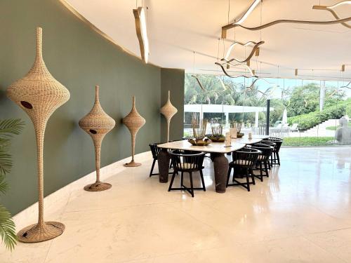 a dining room with a table and chairs at Bolongo 2BR your exclusive oceanfront escape in Punta Mita