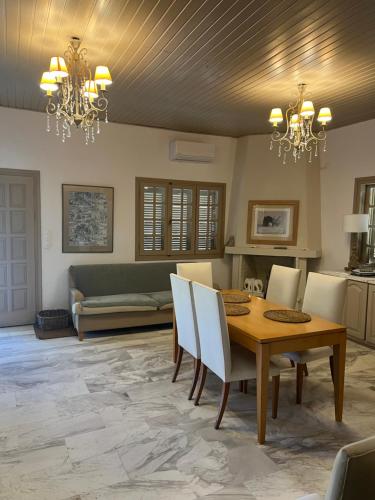 a dining room with a table and chairs at Olive House near the sea in Kharokopión