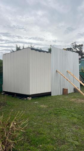 a large white building in a field of grass at Casa Acantilados Suites in Mar del Plata