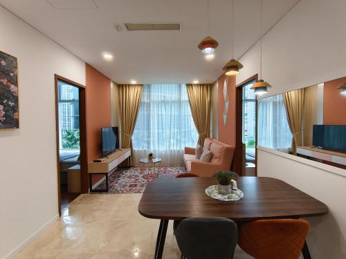 un salon avec une table et des chaises en bois dans l'établissement Sky Suites KLCC Apartment by Family Room Stay, à Kuala Lumpur