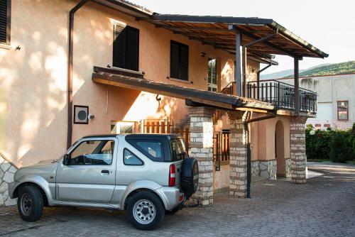 a silver truck parked in front of a building at Agriturismo il filo di Arianna in Coppito