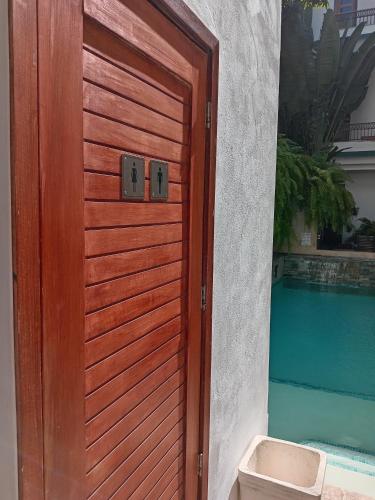 a wooden door to a house with a pool at Boutique Hotel Casa Grande, Banana Chica, Estudio superior con cocina in Santo Domingo