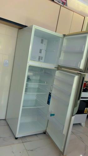 a refrigerator with its door open in a kitchen at Casas Paradisiaca Pagamento Automática in Caldas Novas