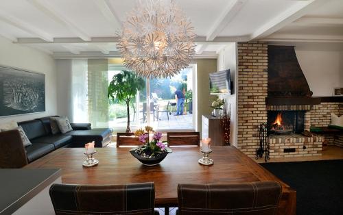 a living room with a table and a fireplace at Haus Daniela Superior in Cochem
