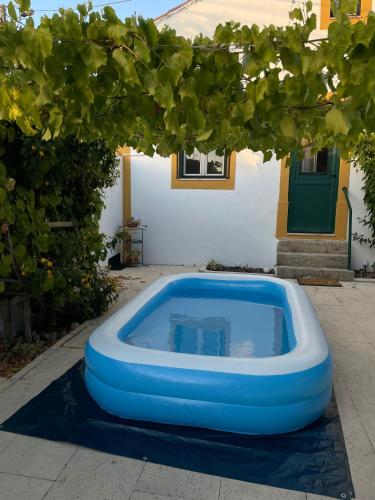 a blue pool in front of a house at Casa 2 Jardins in Olaia
