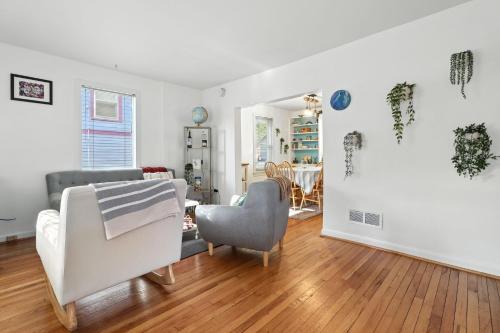 a living room with two chairs and a table at La Casa Naranja home in Ann Arbor