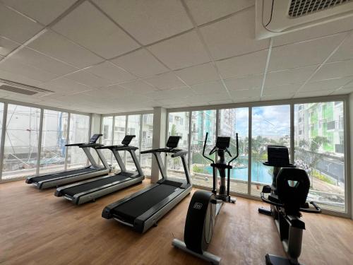 a gym with a row of treadms and elliptical machines at Casa Amalia by Casa Mira Mandaue in Mandaue City