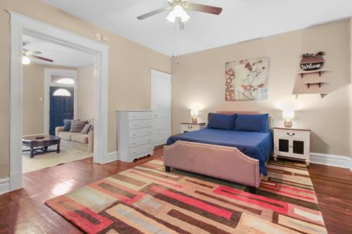 a bedroom with a blue bed and a living room at 1BR Apartment with WiFi & Laundry near Downtown in Carondelet