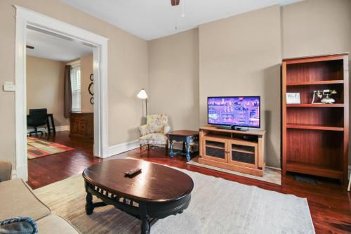 a living room with a tv and a coffee table at 1BR Apartment with WiFi & Laundry near Downtown in Carondelet