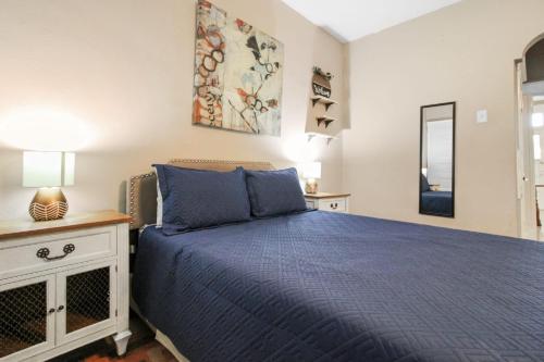 a bedroom with a blue bed and a window at 1BR Apartment with WiFi & Laundry near Downtown in Carondelet