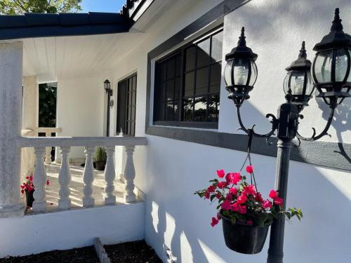 a street light with flowers in a pot on a porch at Casa Bugambilia near Miami Airport in Miami